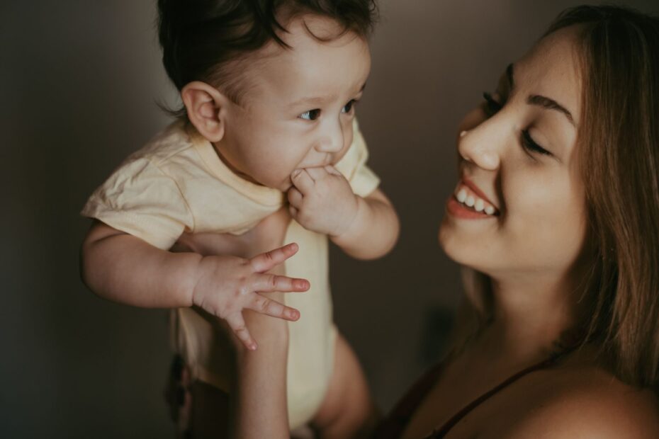 Mãe sorrindo para o bebê no colo